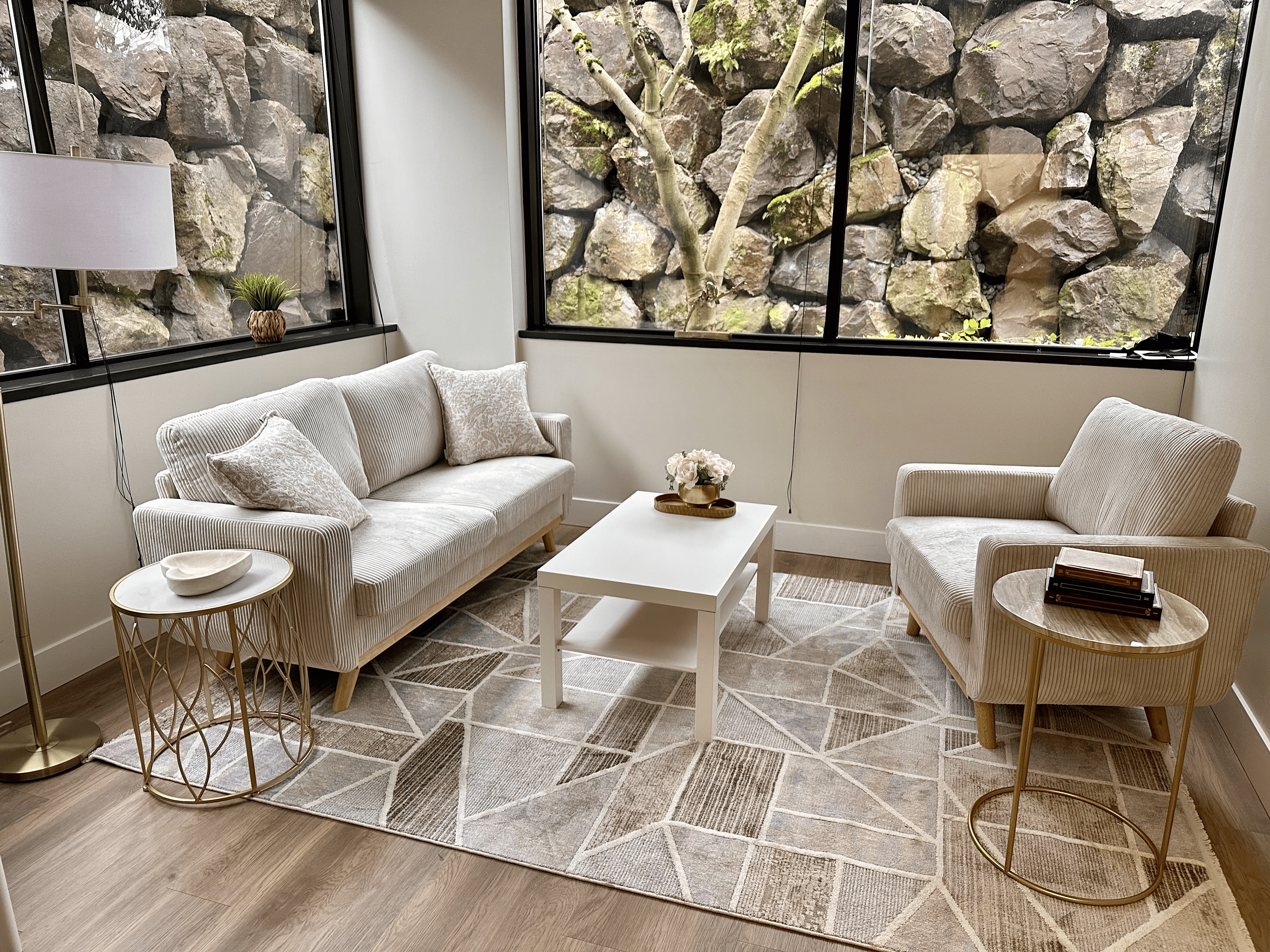 A calm coaching room with a sofa and chair